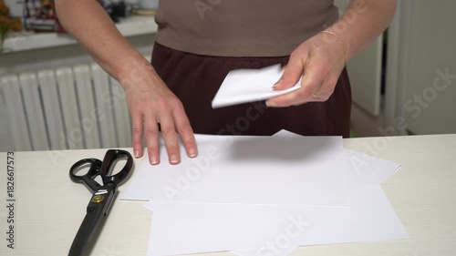 Learn how to make a simple paper craft using scissors and sheets in a cozy home setting. Enjoy the process of cutting and folding as creativity unfolds.