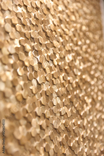 Golden hexagon background with soft metallic shine and modern geometric texture. Minimalistic and elegant design for premium visuals.