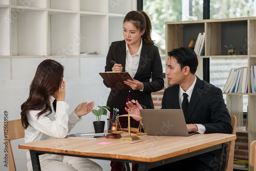 Group of male and female lawyers are giving legal advice in an office.
