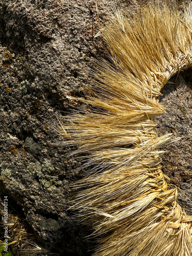 A hand-woven wreath of grass stalks
