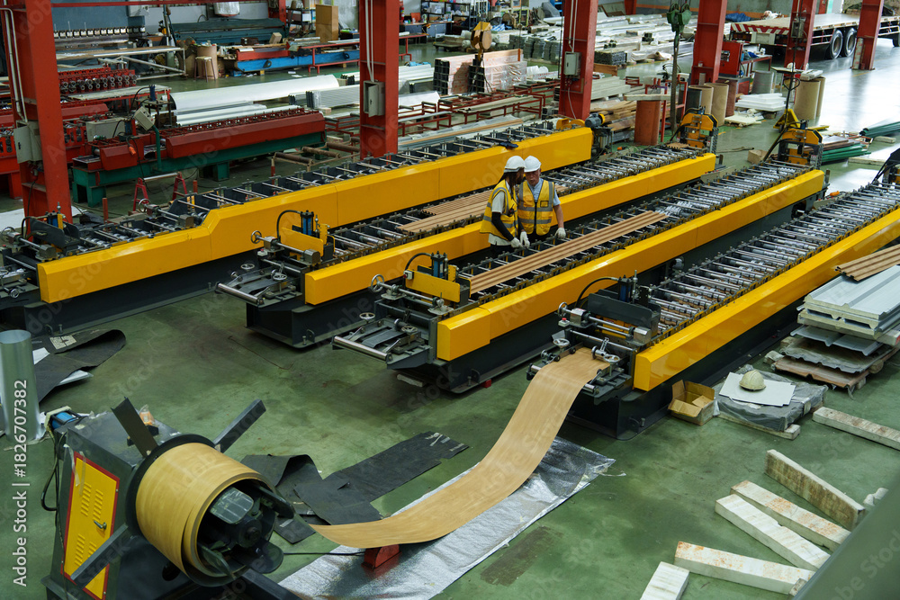 Fototapeta premium Engineers and staff are inspecting systems and components in a metal sheet and metal roofing manufacturing plant.