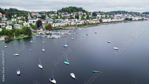 Drone flight over Gmunden yacht harbor turning toward town center
