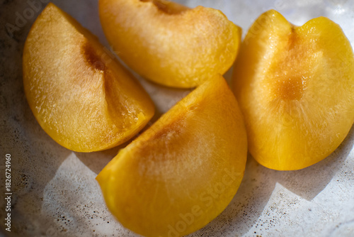 Peach on a plate. Pieces of fresh juicy peach on a plate.