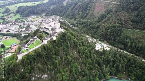Drone orbit around Werfen Castle with hillside elevator in view
