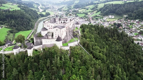 Drone orbit around Werfen Castle with valley town view
