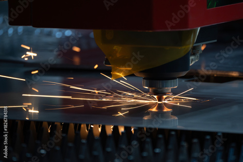 Close up scene the fiber laser cutting machine cut the metal plate control by CNC program.