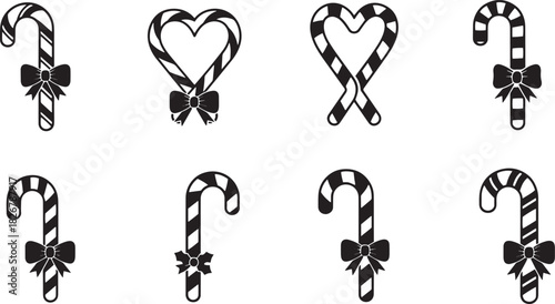 Christmas candy canes with bows on white background.