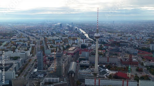 Aerial establishing shot of downtown Berlin featuring famous Fernsehturm television tower in Alexanderplatz and urban skyline on a cloudy day
