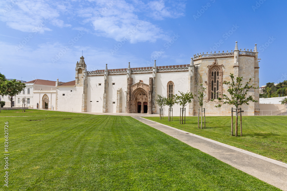 Fototapeta premium The Monastery of Jesus of Setubal, a 15th-century Portuguese national monument with beautiful Manueline style architecture, set against a blue sky.