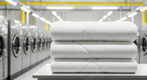 Stack of Clean White Bedding in a Bright Laundry Room with Washing Machines