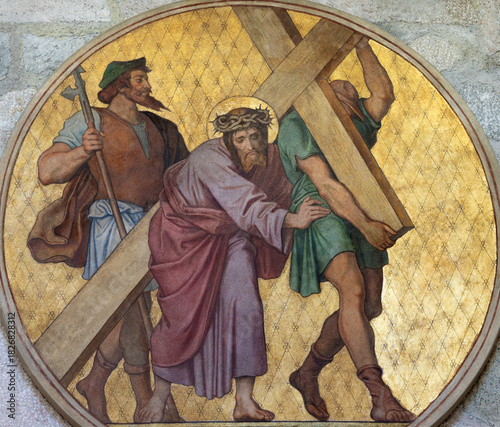 Photography BAD REICHENHALL, GERMANY - SEPTEMBER 8, 2025: The fresco Simon of Cyrene help Jesus to carry his cross (cross way station) in the church St