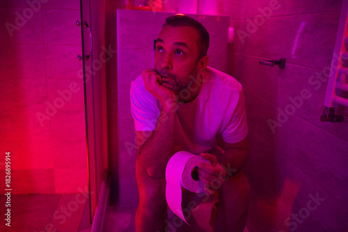 Man with urge to go to the toilet at home.