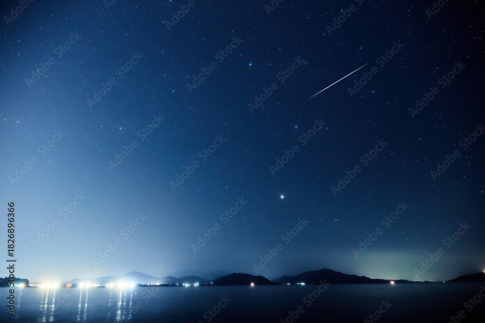 Fototapeta premium Milky way stars over ocean sea waters.