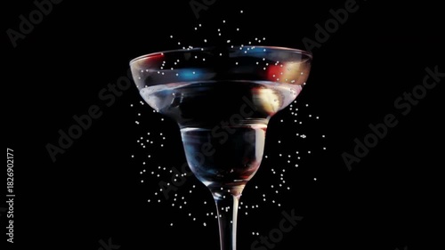 Halo forming around glass, olive skewer dropping, liquid splashing and settling, showing product