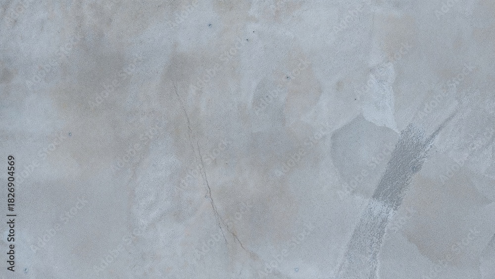 Obraz premium A damaged concrete surface with cracks and patches showing wear and tear.