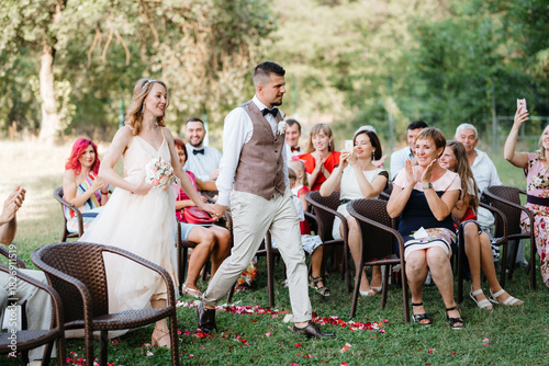 wedding ceremony of a young couple in love on a green meadow