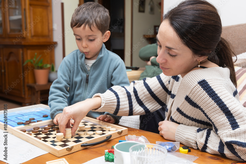 Fototapeta premium Warm Family Moment: A Grandfather, Mother, and Son Joyfully Playing a Board Game Together