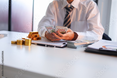 Bilde på lerret Businessman investing in gold to diversify portfolios hedge against inflation and currency depreciation