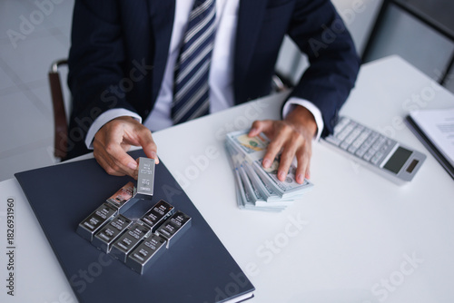 Silver Trading Businessman invest in trading silver, calculating profit price of  buying and selling silver in the market.