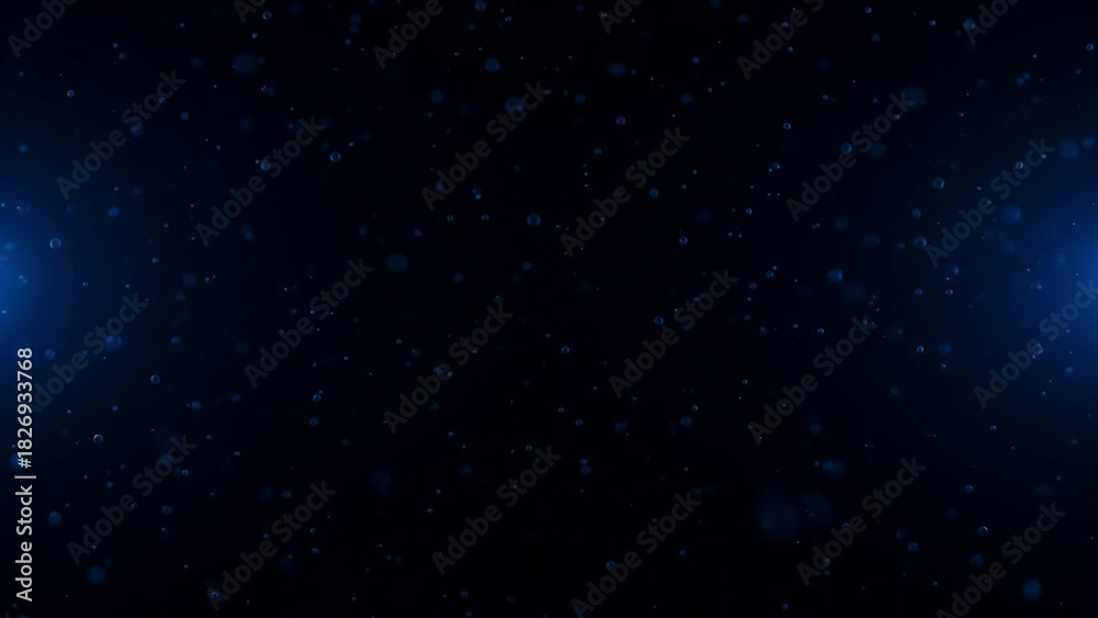 Obraz premium Abstract blue bokeh effect with floating particles on a dark background, perfect for digital designs and presentations