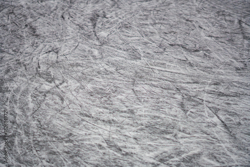 Canvas Print Scratched ice rink surface after heavy use shows skate marks and frozen ice text