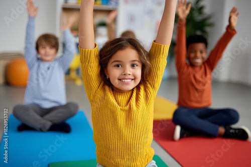 Energetic children of diverse ethnicities are joyfully participating in a yoga class, raising their hands in excitement on colorful mats in a bright classroom environment