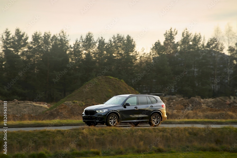 Fototapeta premium Vehicle driving on a sunny day in countryside