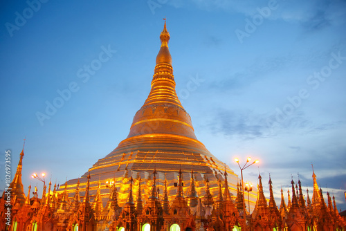 The main stupa of the Shwedagon Pagoda lit up at twilight in the evening. It is Yangon's most famous landmark and the most sacred Buddhist pagoda in country. The temple is in Yangon, Myanmar.