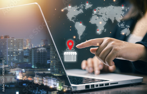 A user selecting a global store location on a digital world map via laptop, representing international business expansion, logistics, navigation, and global market connectivity.