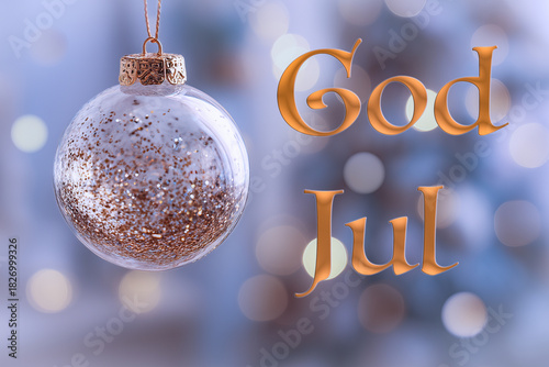 God Jul. Swedish greeting. Focus on the golden Christmas tree ball, reflecting tiny specks of light, surrounded by a dreamy bokeh background of cozy holiday atmosphere. Merry Christmas in Swedish.