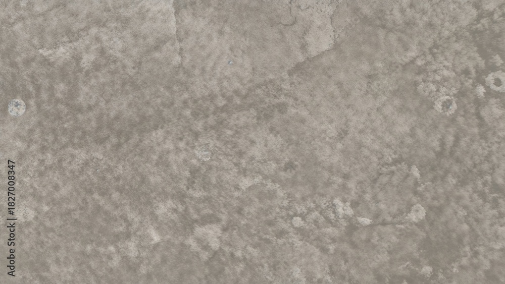 Naklejka premium A textured surface with a rough, concrete-like appearance, showing irregular patches and subtle color variations.