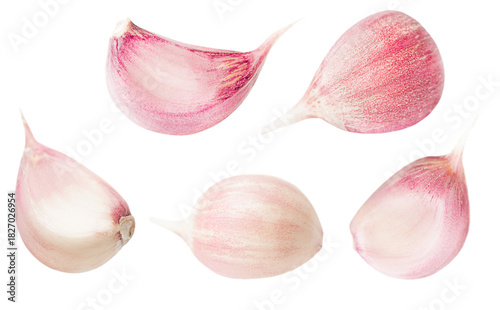 unpeeled garlic cloves on a white isolated background