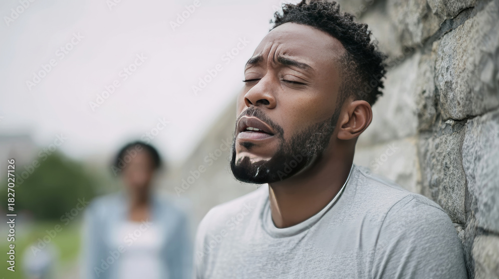 Fototapeta premium African American man struggling with breathing difficulty, suffering from asthma attack episode outdoors