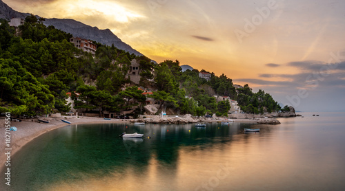 Fototapeta Naklejka Na Ścianę i Meble -  Croatia, Dalmatia, the Adriatic coast at sunrise, with the Biokovo Mountains and forests in the background. The village of Brela is a summer resort on the Makarska Riviera.