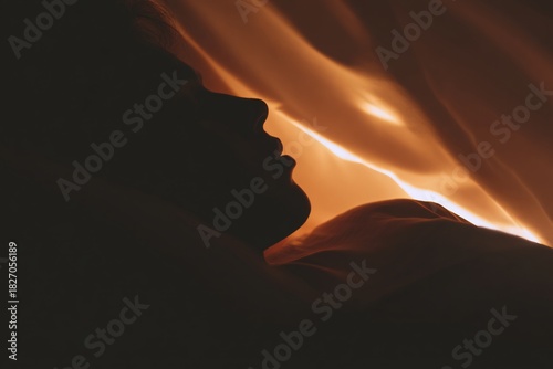 Artistic low-light silhouette of a woman expressing desire
