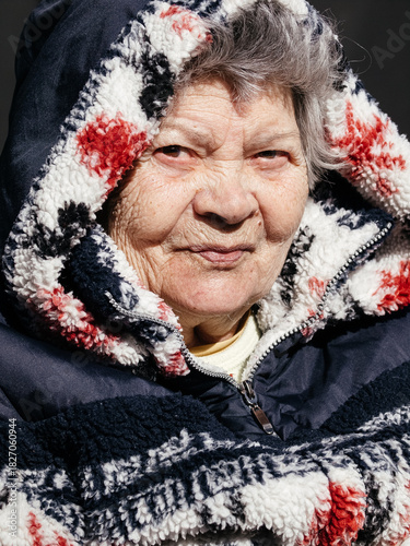 Portrait Of Elderly Woman In Warm Winter Hooded Jacket: Close-Up Outdoor Scene Showing Gentle Expression And Soft Natural Light