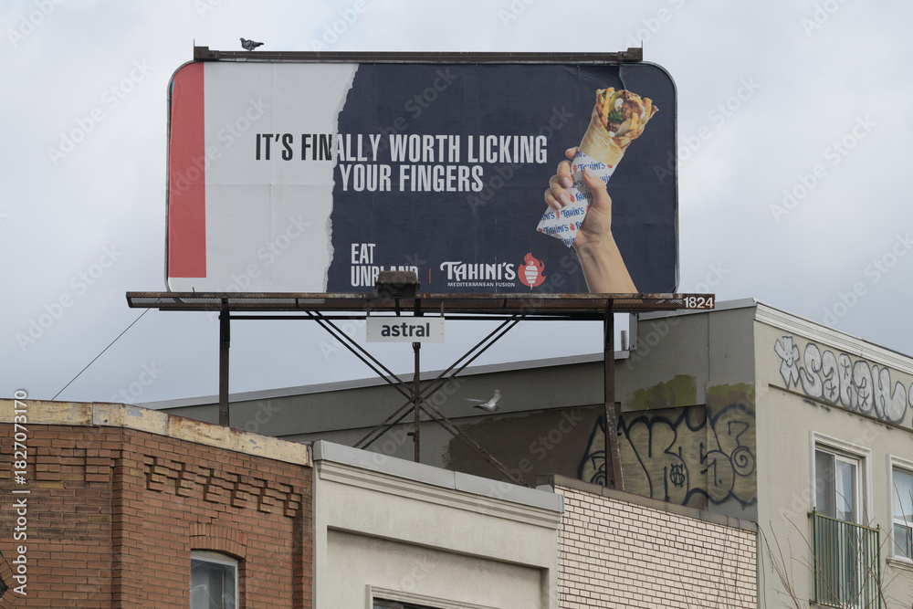 Fototapeta premium rooftop billboard for Tahini’s, a Middle Eastern restaurant, located near 890 Bloor St W, Toronto
