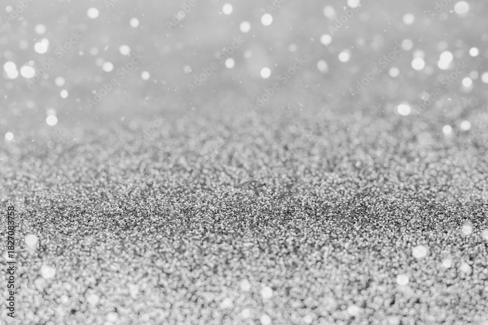 Obraz premium Shimmering silver glitter texture with bokeh lights for background and design projects