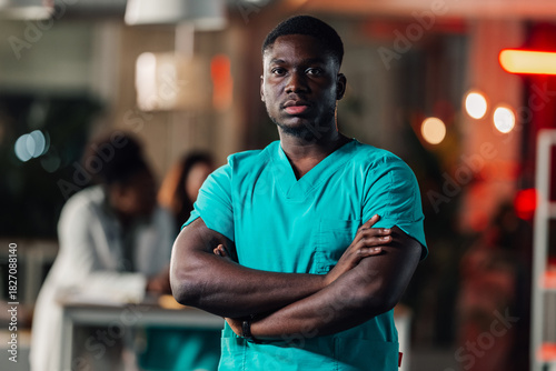 Young black healthcare worker standing confident in scrubs