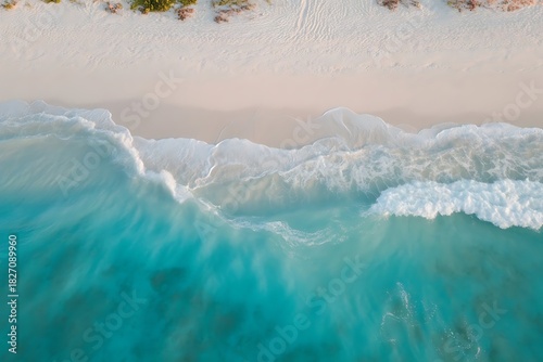 Fototapeta Naklejka Na Ścianę i Meble -  Aerial View of Turquoise Ocean Waves Crashing on a White Sand Beach turquoise water