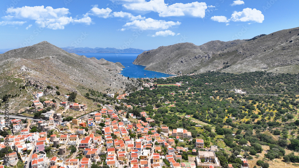 Naklejka premium Aerial drone photo of picturesque seaside main town and port of Yialos of Symi island with colorful neoclassical houses and traditional character, Dodecanese, Greece