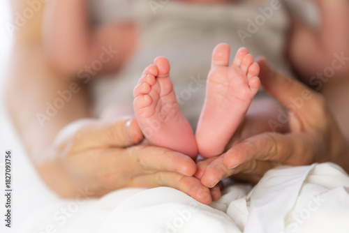 Parent holding baby feet showing love and care
