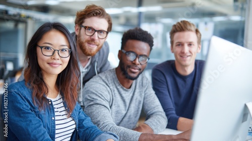 Wallpaper Mural Diverse Team Collaboration in Modern Office, Smiling and Confident, Focusing on Computer Screen Torontodigital.ca