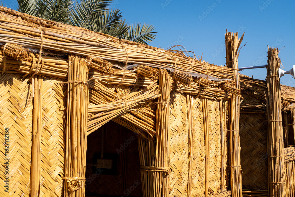 Naklejka premium Nasiriyah, Iraq - November 20, 2025: Frontal View of the Grand Facade and Entrance of a Traditional Reed