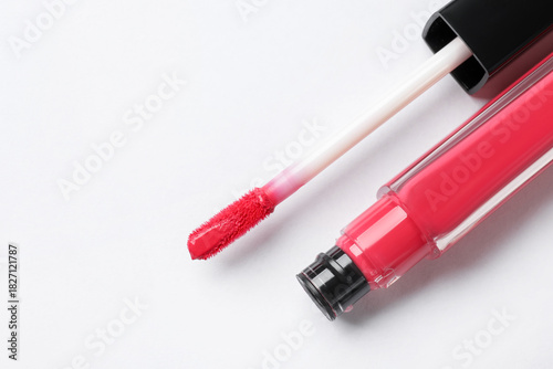 Obraz na plátně Beautiful lip gloss with applicator on white background, top view