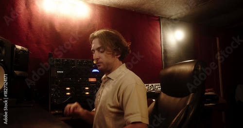Sound engineer adjusting audio equipment in recording studio