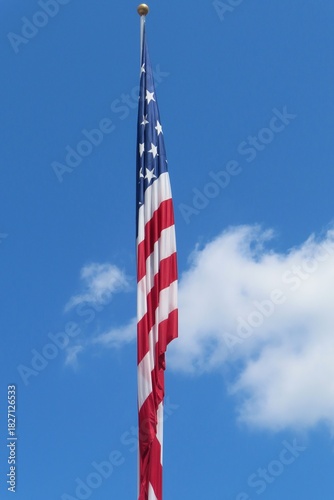 American flag on blue sky and clouds background