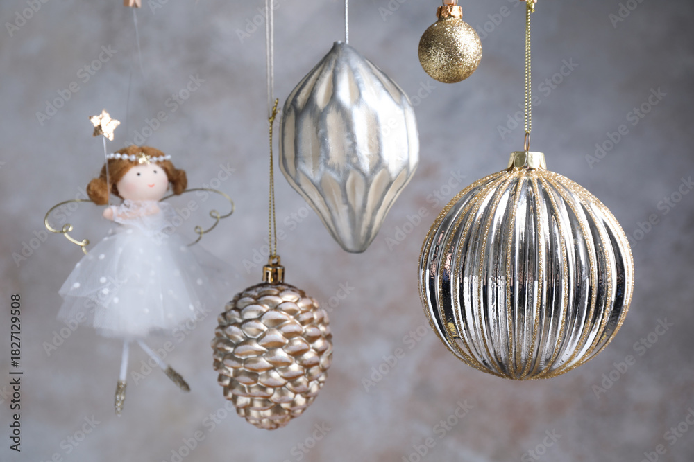 Obraz premium Beautiful Christmas decor hanging near light grey wall, closeup