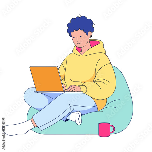 Non-binary person working on laptop while sitting on bean bag at home  