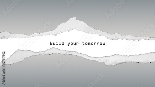 Future-focused quote “Build your tomorrow” on grey gradient background with torn paper texture. Motivational design about planning, vision and progress.
